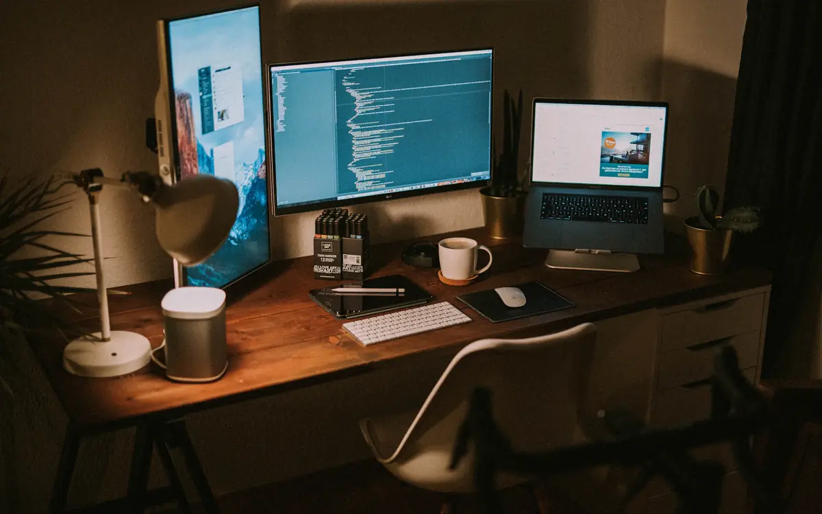 About Us 2 A developer workspace with monitors and a laptop, where SEO tools are built and tested