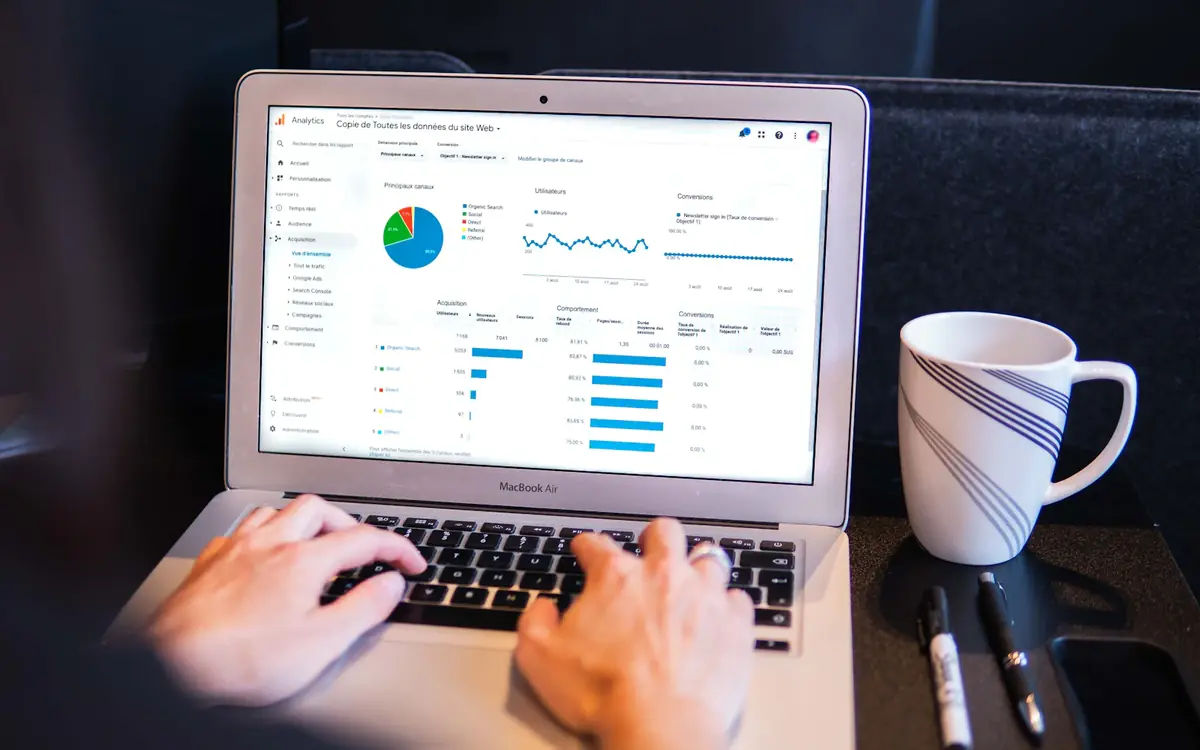 SEO specialist checking on-page SEO data on a laptop next to a coffee cup